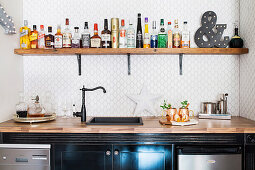 House bar: counter with sink, wooden shelf above with drinks