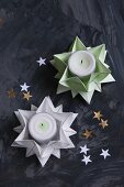 Folded green and white paper stars used as tealight holders
