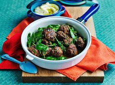 Beef and herbs meatballs with spinach,