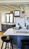 Bar stools at counter in quirky kitchen with odd angles