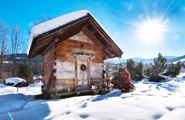 Small wooden hut in snowy winter landscape