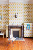 Patterned wallpaper and fireplace in children's bedroom in period apartment