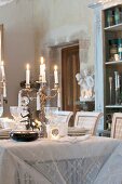 Candles on festively set dining table in historical interior