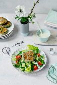 A garden salad with a horseradish dressing and fish burgers