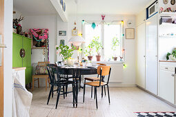 Various chairs around black table in kitchen-dining room