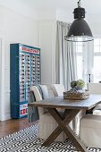 Old vending machine in elegant dining room with loose-covered chairs