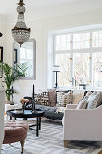 Elegant living room in pastel shades with chandelier