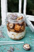 Miso soup in a glass jar with miso paste, Udon noodles, fried Teriyaki tofu, Shiitake mushrooms and sprouts