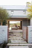 Architect-designed house with open garden gate and open façade