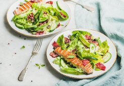Healthy energy boosting spring salad with grilled salmon, blood orange, olives, cucumber and quinoa