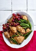 Chicken casserole with grapes, sugar snap peas and asparagus