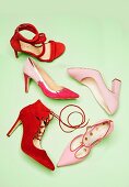 Various high-heeled shoes in pink and red