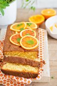 A sliced loaf-shaped orange cake