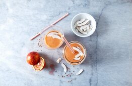Blood orange smoothie with apple, coconut and flaxseeds (seen from above)