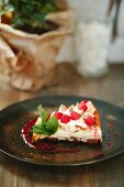 A slice of raspberry tart with fresh mint