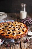 Blackberry pie with double crust and decorative crust on a wooden surface