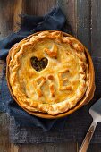 A meat pie with 'Pie' lettering and a dough heart