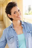 Brunette with backcombed hair woman wearing patterned, embroidered tunic