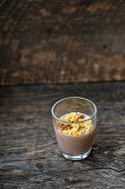 Cocoa pudding with walnuts and flakes in a glass