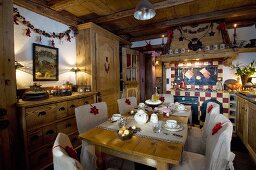 Dining table set with pastries and tea in festively decorated country-house kitchen