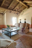 Terracotta floor and exposed roof structure in Mediterranean living room