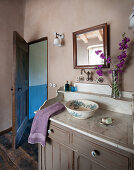 Old washbasin on cabinet with marble top