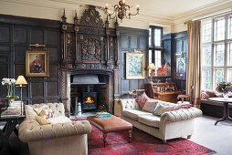 Historical panelled wall and open fireplace in living room