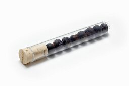 Juniper berries in a test tube