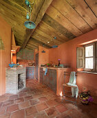 Mediterranean kitchen with terracotta tiles and fireplace