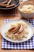 Sauerkraut with small Nuremberg sausages and mashed potato