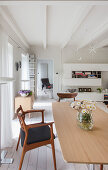 Designer chairs and dining table in open-plan interior