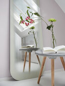 Concrete side table in front of full-length mirror with frosted rim