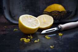 Lemons with zest and a vegetable peeler