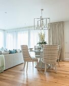 Flower arrangement on round glass table in elegant interior