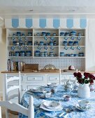 Collection of blue and white crockery in dresser in rustic kitchen