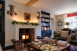 Wood-burning stove in fireplace of festively decorated, traditional interior