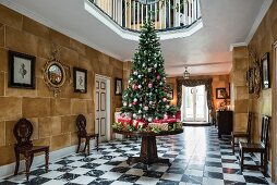 Christmas tree and presents on table in large reception hall