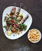 Various grilled meat kebabs with French fries (Lebanon)