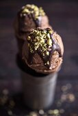 Chocolate ice cream with sliced pistachios on the top