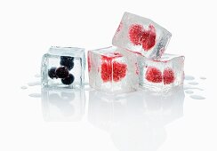 Ice cubes with blueberries and raspberries