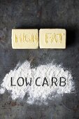 The words 'high fat' and 'low carb' spelled out in butter and flour