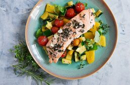 Herbed salmon on a bed of rainbow vegetables