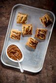 Sausage rolls with hot tomato and garlic chutney