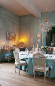 Festively set table in antique dining room with panelled walls