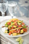 Tacos filled with pork, coleslaw, avocado and tomato salsa