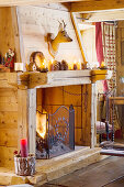 Rustic open firepalace with wooden surround in chalet