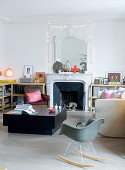 Open fireplace and chunky coffee table in eclectic living room