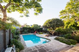 Enclosed garden with a large pool and trees