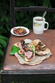 A whole grain sandwich with lamb's lettuce, roasted duck breast and wild mushrooms