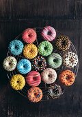 Colorful mini American donuts on wooden background